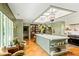 Spacious kitchen with a large marble island, designer lighting and adjacent seating area at 333 W Confederate Cir, Charleston, SC 29407