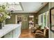Bright kitchen with a skylight, green tile, marble countertops, and patterned armchairs at 333 W Confederate Cir, Charleston, SC 29407