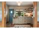 Charming kitchen featuring marble countertops, open shelving, and a blue accent door at 333 W Confederate Cir, Charleston, SC 29407