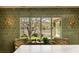Bright living room featuring a window with lake views, green tile walls, and patterned armchairs at 333 W Confederate Cir, Charleston, SC 29407