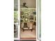 Inviting living room with stylish wallpaper, comfortable seating, and sliding doors to the outdoor living and pool at 333 W Confederate Cir, Charleston, SC 29407