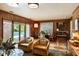 Bright living room with wood paneled walls and a view of the sparkling pool at 333 W Confederate Cir, Charleston, SC 29407
