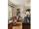 Inviting living area features a stylish leather chair, ottoman, bookshelf, and herringbone floors at 333 W Confederate Cir, Charleston, SC 29407