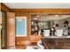Elegant living room with wood paneling, built-in shelving, and doorway to open living space at 333 W Confederate Cir, Charleston, SC 29407