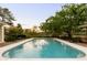 A backyard oasis featuring a private pool, lush landscaping, and mature trees at 333 W Confederate Cir, Charleston, SC 29407