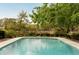 A gorgeous swimming pool features tile trim, clear blue water, and a picturesque view of trees and marsh at 333 W Confederate Cir, Charleston, SC 29407
