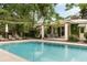 Relax by the in-ground pool and admire the lovely pool house with outdoor furniture and lush landscaping at 333 W Confederate Cir, Charleston, SC 29407
