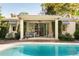 Exterior pool house features columns, ceiling fan and an outdoor sitting area by the luxurious pool and brick patio at 333 W Confederate Cir, Charleston, SC 29407