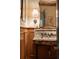 Elegant powder room with custom marble sink, designer wallpaper, and vintage-inspired lighting at 333 W Confederate Cir, Charleston, SC 29407