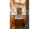 Charming powder room showcasing marble sink, wood paneling, and designer wallpaper at 333 W Confederate Cir, Charleston, SC 29407