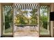 The image captures a charming splash pool enclosed by brick, featuring outdoor chairs and tables, accessed through french doors at 333 W Confederate Cir, Charleston, SC 29407