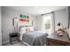 Stylish bedroom features a comfortable bed, unique wall decor, window with curtains, and a wooden dresser at 339 Pine Crest View Dr, Summerville, SC 29486