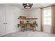 Cozy bedroom showcasing a desk area with shelves, a large window, a unique chandelier, and neutral walls at 339 Pine Crest View Dr, Summerville, SC 29486