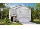 Charming two-story home featuring a white exterior, attached garage, and beautifully landscaped front yard at 339 Pine Crest View Dr, Summerville, SC 29486