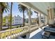 Spacious balcony with white columns offering views of the street and palm trees at 34 Smith St, Charleston, SC 29401