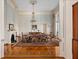 Traditional dining room with hardwood floors, floral wallpaper, and a beautiful chandelier centerpiece at 34 Smith St, Charleston, SC 29401