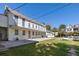 Multi-story building featuring multiple windows, a concrete patio and grassy yard at 34 Smith St, Charleston, SC 29401