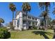 Stunning two-story home with a lawn, mature palm trees and a charming column-lined balcony at 34 Smith St, Charleston, SC 29401