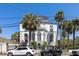 Classic two-story home with palm trees, detailed trim, and wrought iron fences at 34 Smith St, Charleston, SC 29401
