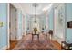 Inviting foyer featuring hardwood floors, a crystal chandelier, and soft blue walls at 34 Smith St, Charleston, SC 29401