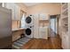 Practical laundry room with stacked washer and dryer units, utility sink, and ample cabinet space at 34 Smith St, Charleston, SC 29401