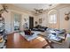 Sophisticated living room with hardwood floors, neutral walls, and an arched window overlooking the outdoor scenery at 34 Smith St, Charleston, SC 29401