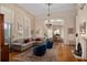 A spacious living room with fireplace, chandelier, and views through an arched doorway at 34 Smith St, Charleston, SC 29401