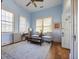 Cozy living room with blue walls, large windows, ceiling fan, and area rug at 34 Smith St, Charleston, SC 29401