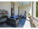 Inviting covered porch featuring outdoor seating and a blue patterned rug at 34 Smith St, Charleston, SC 29401