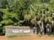 Welcoming Saint Johns Lake entrance sign surrounded by lush landscaping provides a charming first impression at 3438 Great Egret Dr, Johns Island, SC 29455