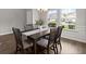 Bright dining room features a modern chandelier, wainscoting, and natural light at 3438 Great Egret Dr, Johns Island, SC 29455