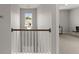 Hallway features a view of an adjacent room through a railing with natural light at 3438 Great Egret Dr, Johns Island, SC 29455
