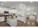 Open kitchen featuring white cabinets, granite countertops, an island, and modern appliances at 3438 Great Egret Dr, Johns Island, SC 29455