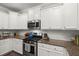 Charming kitchen features granite countertops, stainless steel appliances, and classic white cabinetry at 3438 Great Egret Dr, Johns Island, SC 29455