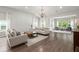 Sunlit living room featuring hardwood floors, neutral paint, vaulted ceilings, and bright windows at 3438 Great Egret Dr, Johns Island, SC 29455