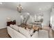 Welcoming living room offers neutral decor, hardwood flooring, chandelier, and easy access to dining at 3438 Great Egret Dr, Johns Island, SC 29455