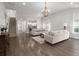 Open-concept living room with hardwood floors, neutral colors, and stairs to the second level at 3438 Great Egret Dr, Johns Island, SC 29455
