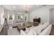 Bright and airy living room with vaulted ceilings, hardwood floors and a decorative chandelier at 3438 Great Egret Dr, Johns Island, SC 29455