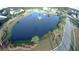 Scenic aerial view of the community pond with fountain and lush greenery showcases the natural beauty of the area at 3438 Great Egret Dr, Johns Island, SC 29455