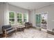 Relaxing sitting area features large windows and access to a covered patio overlooking a lush yard at 3438 Great Egret Dr, Johns Island, SC 29455