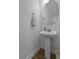 Pedestal sink features classic faucet, oval mirror, with a towel in this stylishly simple bathroom at 4020 Conant Rd, Mount Pleasant, SC 29466
