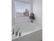 Close-up of a bathroom tub with a garden view window, plus classic fixtures for a relaxing bathing experience at 4020 Conant Rd, Mount Pleasant, SC 29466