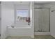 Bright bathroom features a soaking tub, a separate shower, and a window for ample natural light at 4020 Conant Rd, Mount Pleasant, SC 29466