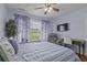 Comfortable bedroom with ceiling fan, accent curtains and furniture, and a wall-mounted television at 4020 Conant Rd, Mount Pleasant, SC 29466