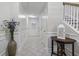 Bright hallway with white wainscoting, decorative table and vase, and staircase access at 4020 Conant Rd, Mount Pleasant, SC 29466