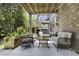 Inviting outdoor patio featuring cushioned seating, a glass-topped table, and a brick exterior wall at 4020 Conant Rd, Mount Pleasant, SC 29466