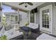 Screened porch features comfortable seating, a ceiling fan, and a fire pit table with relaxing outdoor views at 4020 Conant Rd, Mount Pleasant, SC 29466