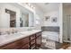 Bright bathroom featuring a double vanity, tub, and shower, creating a functional and modern space at 403 Fox Sparrow Ct, Summerville, SC 29486