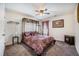 Cozy bedroom featuring a decorative canopy bed, ceiling fan, and a small fireplace at 403 Fox Sparrow Ct, Summerville, SC 29486