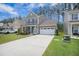 Charming two-story home featuring a well-manicured lawn and an attached two-car garage with ample driveway space at 403 Fox Sparrow Ct, Summerville, SC 29486